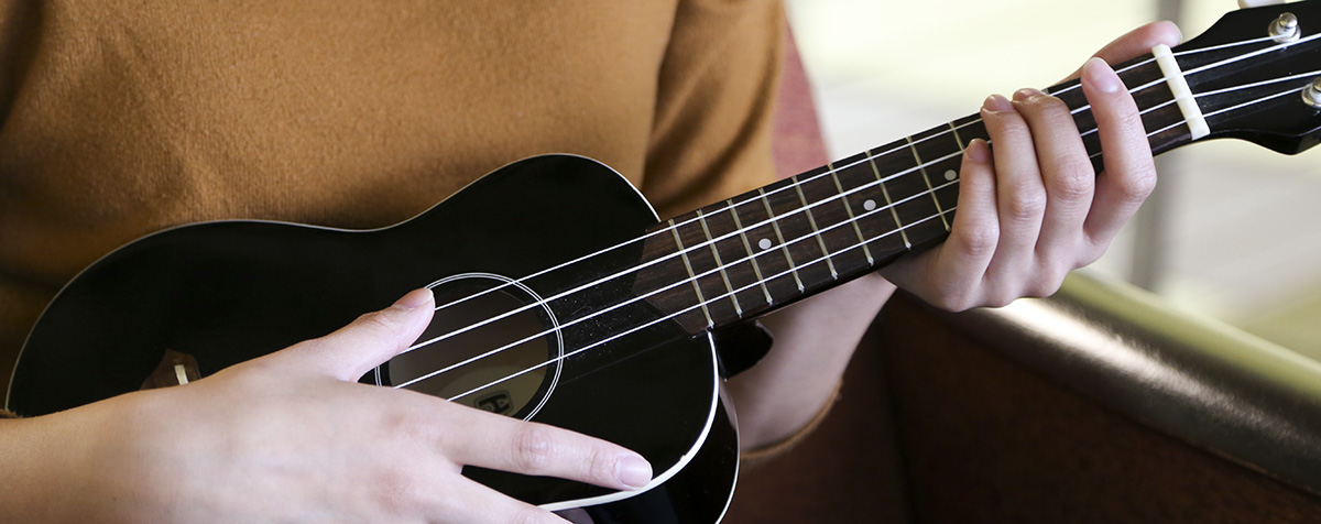 Photo of Jill playing the guitar